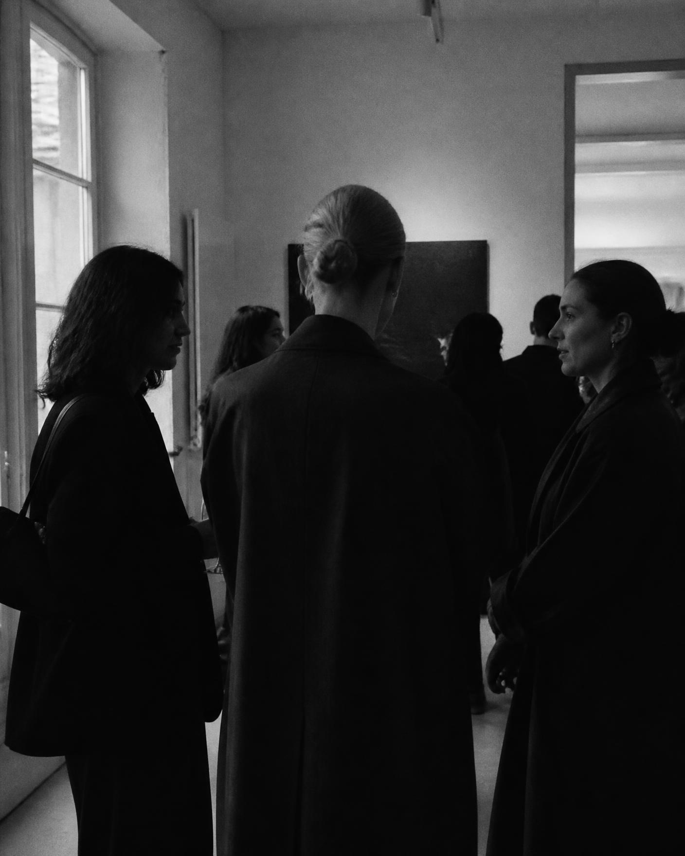 Guests in conversation at a private evening gathering